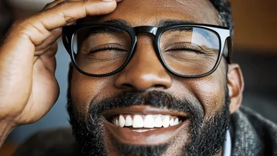 Close Up Of A Smiling Man Wearing Glasses