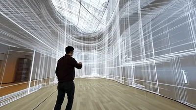 Architect Interacting With Virtual Reality Building Wireframe Model