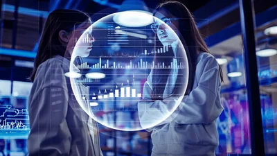Two Young Female Scientists Analyzing Holographic Data Sphere