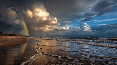 Rainbow Over Tropical Beach With Rolling Ocean Waves