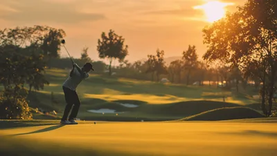 Golfer Hitting A Golf Ball On A Sunny Course