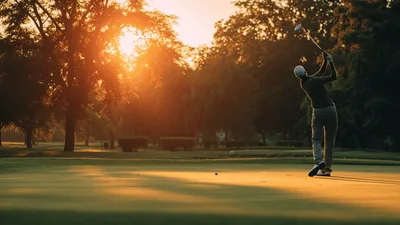 Golfer Performing A Full Swing On A Golf Course