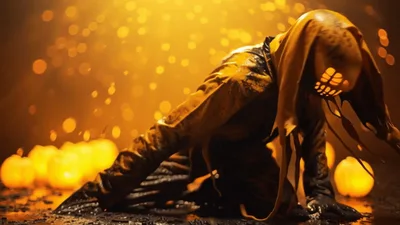 Creepy Slime Covered Figure Kneeling Among Glowing Pumpkins