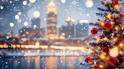 Christmas Tree With Red Ornaments Against Snowy Cityscape