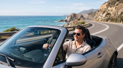 Man Driving Convertible Along Coastal Highway