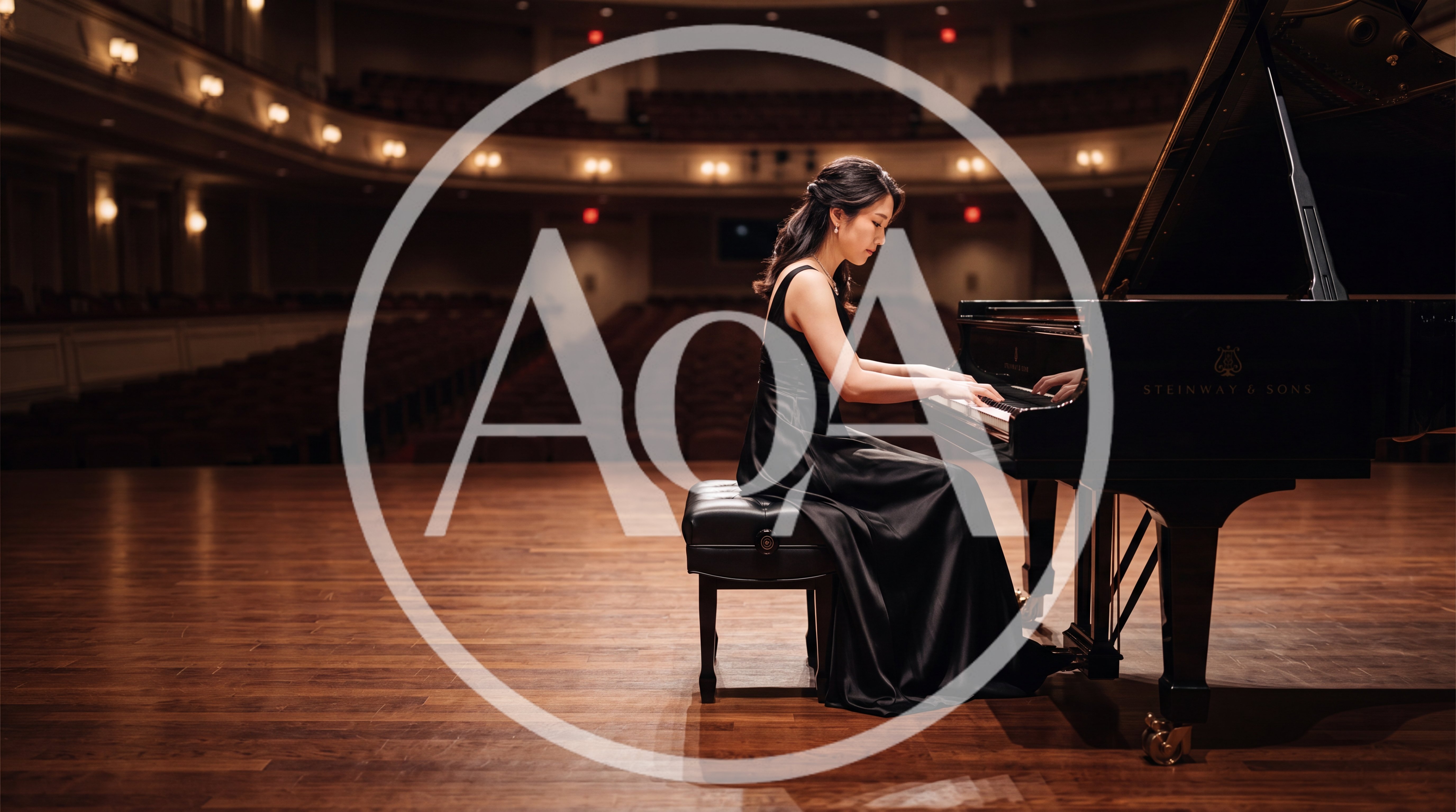 Pianist Performing On Grand Piano In Concert Hall