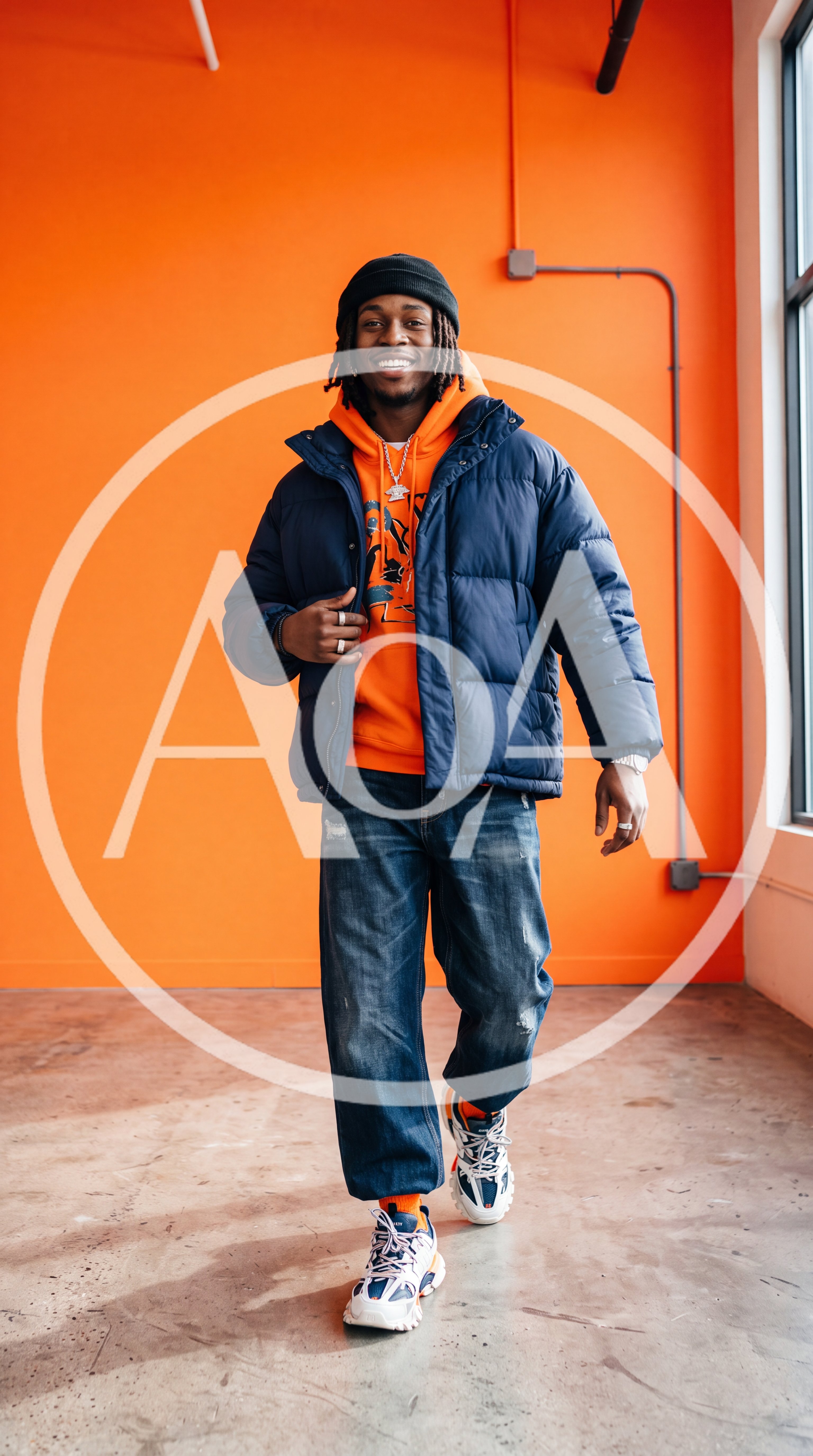 Young Man Walking In Orange Studio