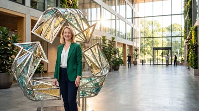 Professional Woman Standing Beside Large Modern Sculpture