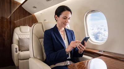 Businesswoman Using Smartphone On Private Jet