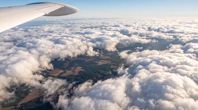 Aerial View From Airplane Window Over Clouds