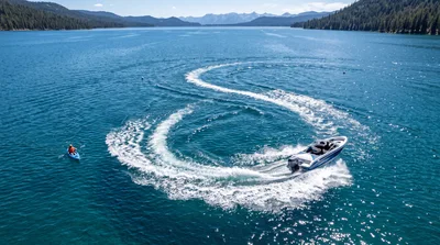 Motorboat Creating S-Shaped Wake Near Kayaker
