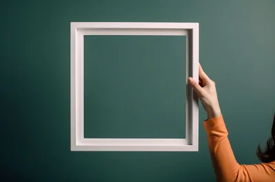 Woman Holding A Blank White Picture Frame