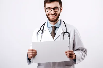 Smiling Male Doctor Holding Blank White Sign