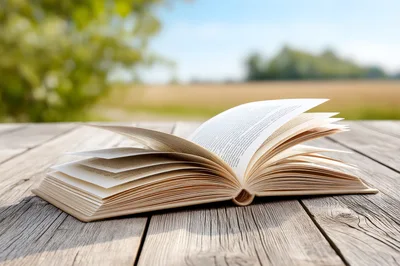 Open Book Resting On A Weathered Wooden Table