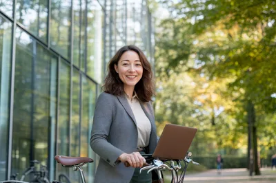 Professional Woman With Laptop And Bicycle Outdoors