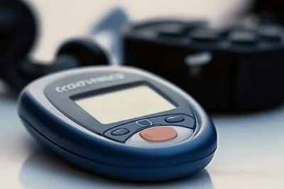 Digital Blood Glucose Meter On A White Surface