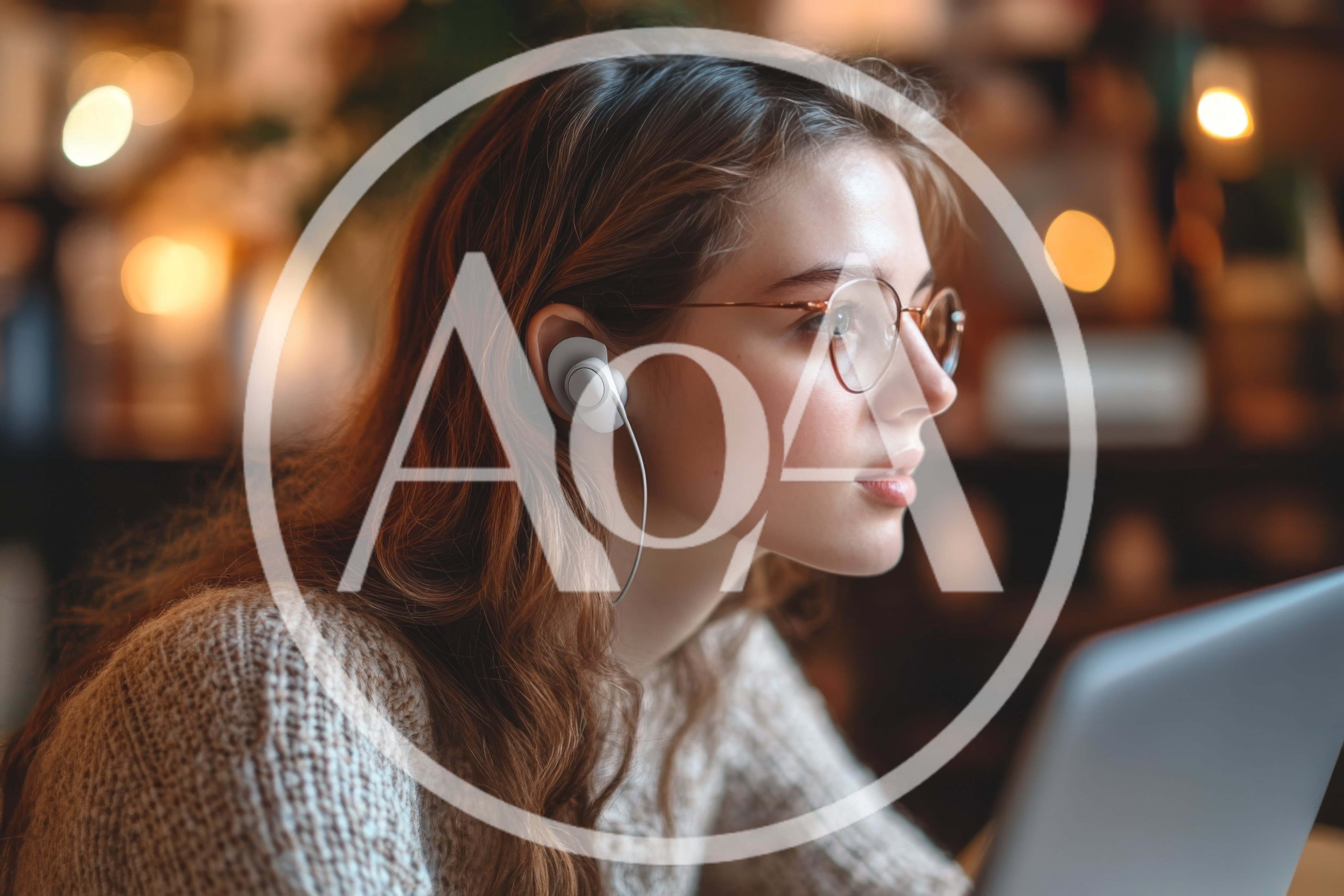 Young Woman Wearing Earbuds Working On Laptop