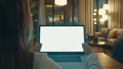 Woman Working On Laptop With Blank Screen At Night