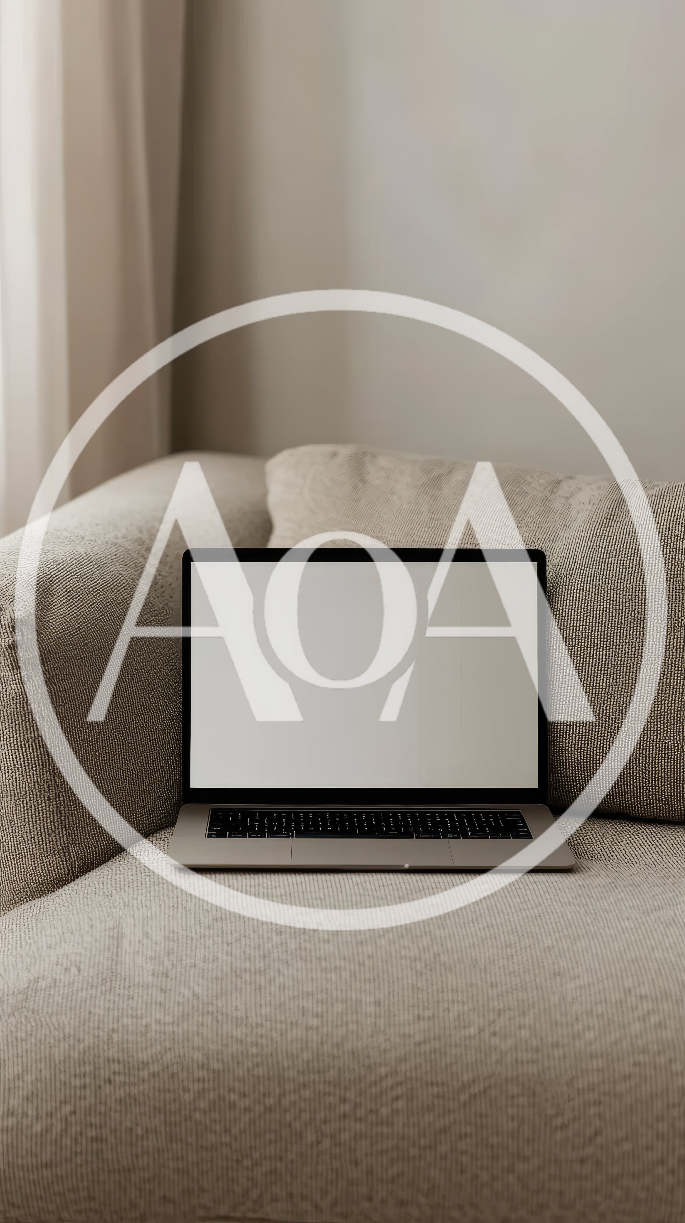 Laptop With Blank Screen Resting On A Fabric Sofa