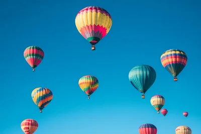 Colorful Hot Air Balloons Floating In Clear Blue Sky