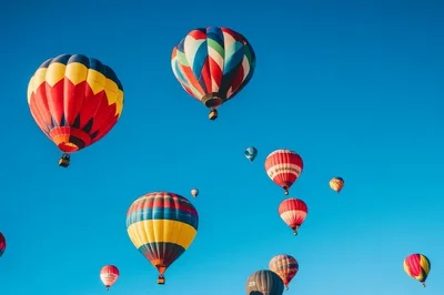 Colorful Hot Air Balloons Floating In Clear Blue Sky