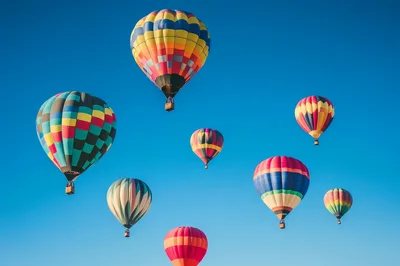 Colorful Hot Air Balloons Floating In Clear Blue Sky