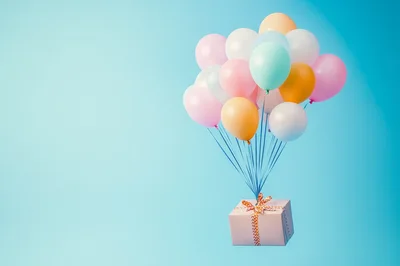 Gift Box Floating With Pastel Balloons