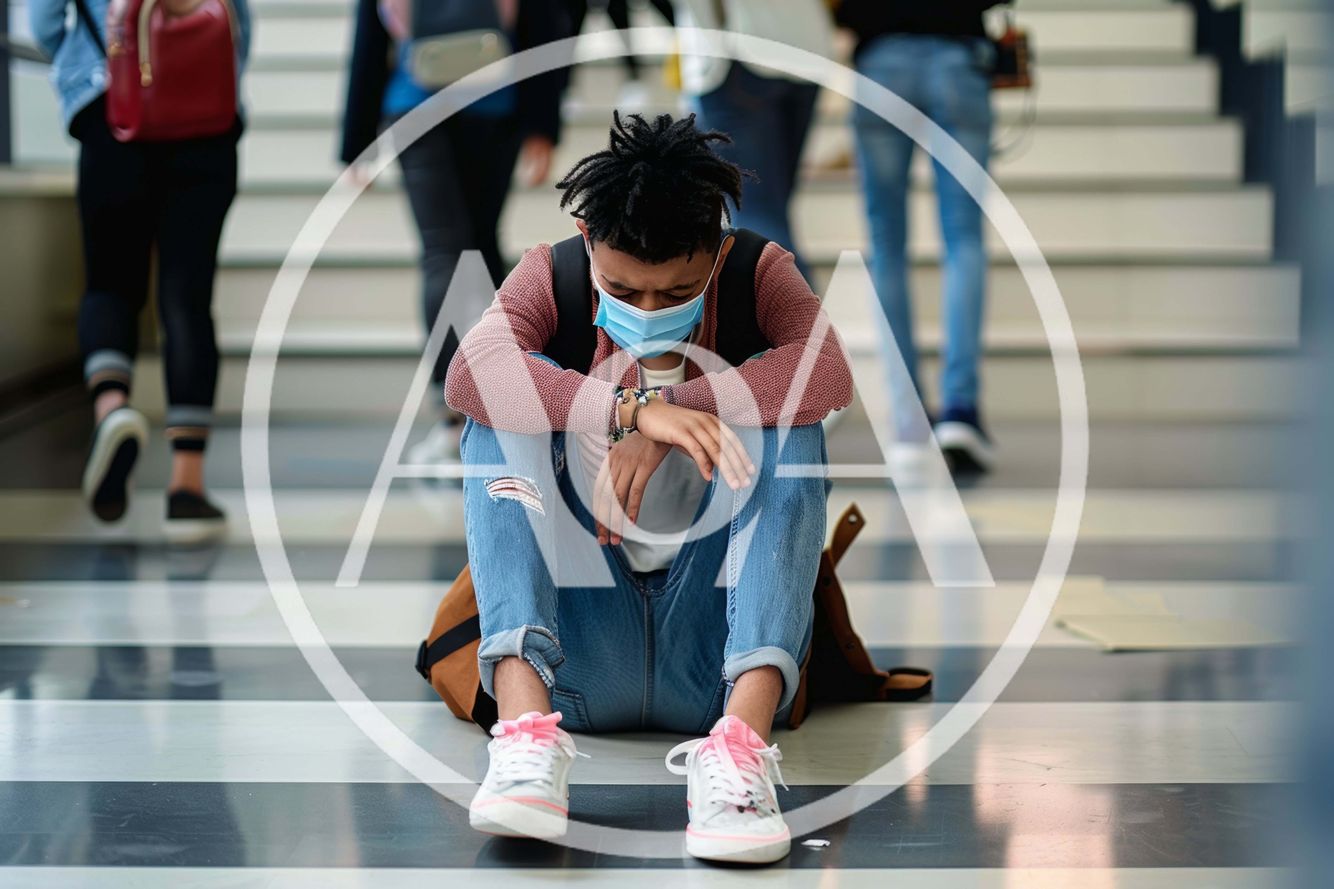 Sad Student Sitting Alone On School Hallway Floor