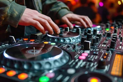 DJ Hands Manipulating Professional Audio Mixing Console