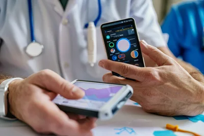 Medical Professionals Reviewing Digital Health Data On Smartphones