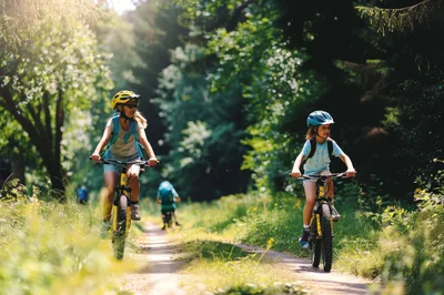 Children Cycling Together On A Sunny Forest Trail