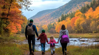 Family Walking Along River During Autumn