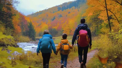 Father And Two Children Hiking In Autumn Forest