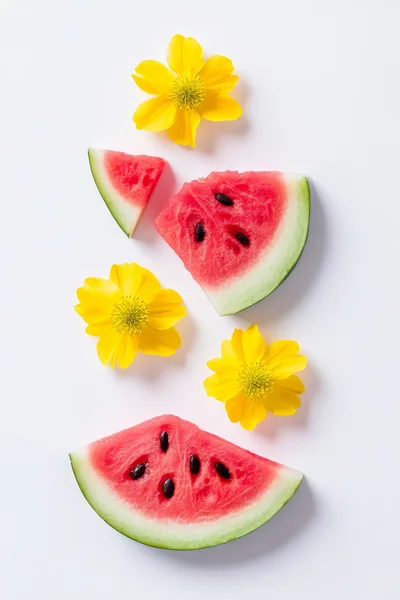 Watermelon Slices and Yellow Flowers on White Background