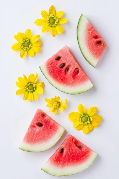 Watermelon Slices and Yellow Flowers on White Background