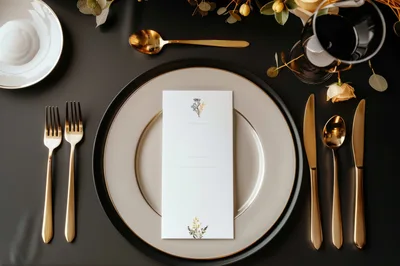 Elegant Table Setting With Menu Card And Gold Cutlery