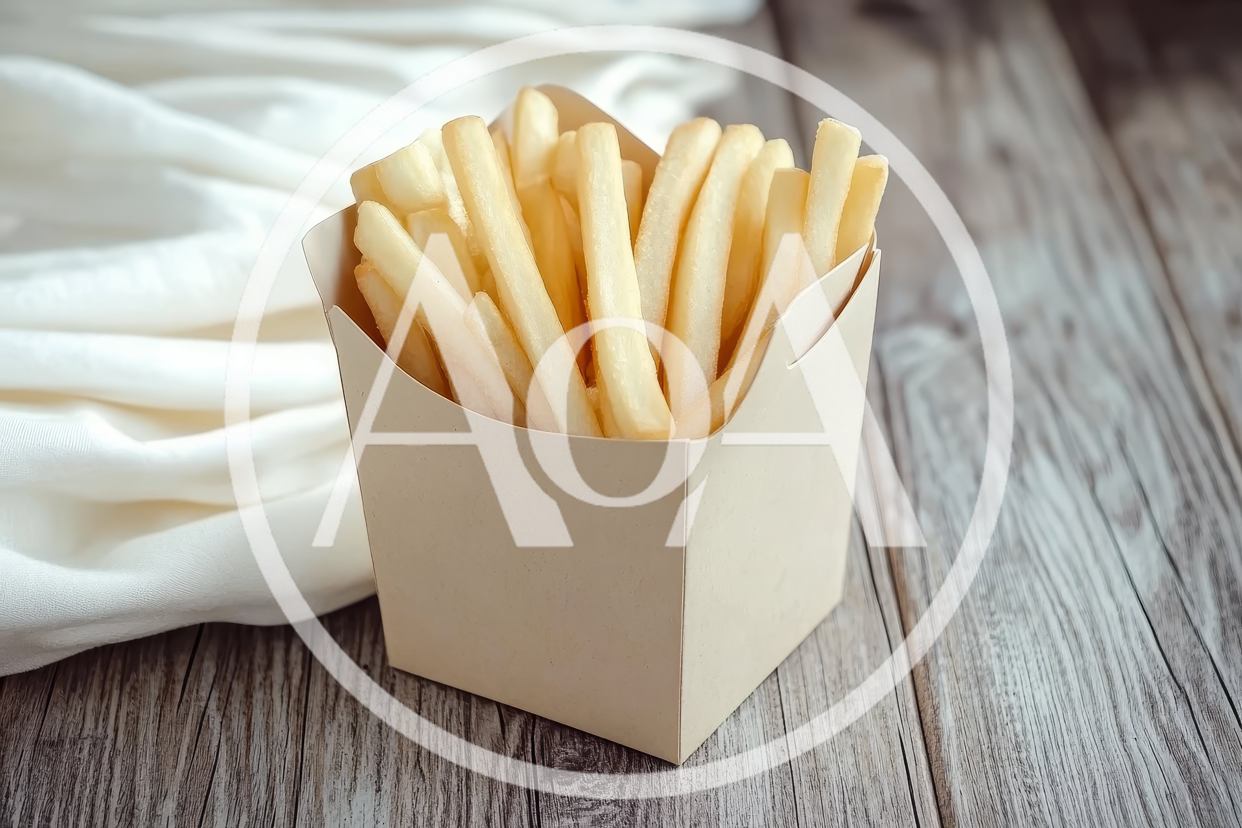 French Fries In A Paper Box On Wooden Table