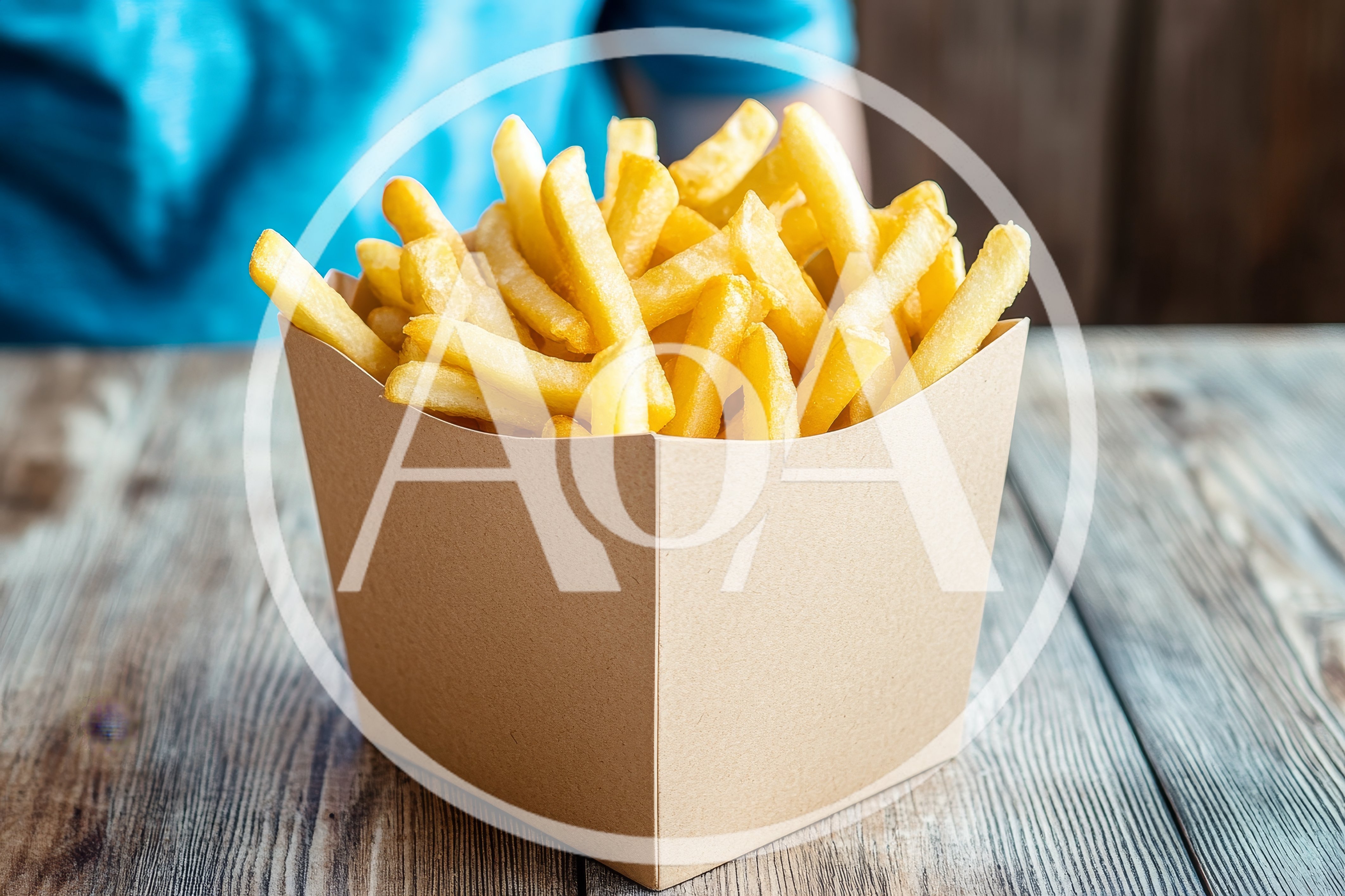 French Fries In A Cardboard Box On Wooden Table