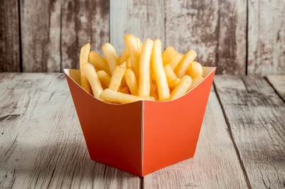 Crispy French Fries In A Red Paper Container