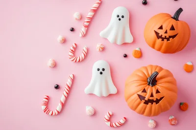 Halloween Candy and Jack-O-Lanterns on Pink Background