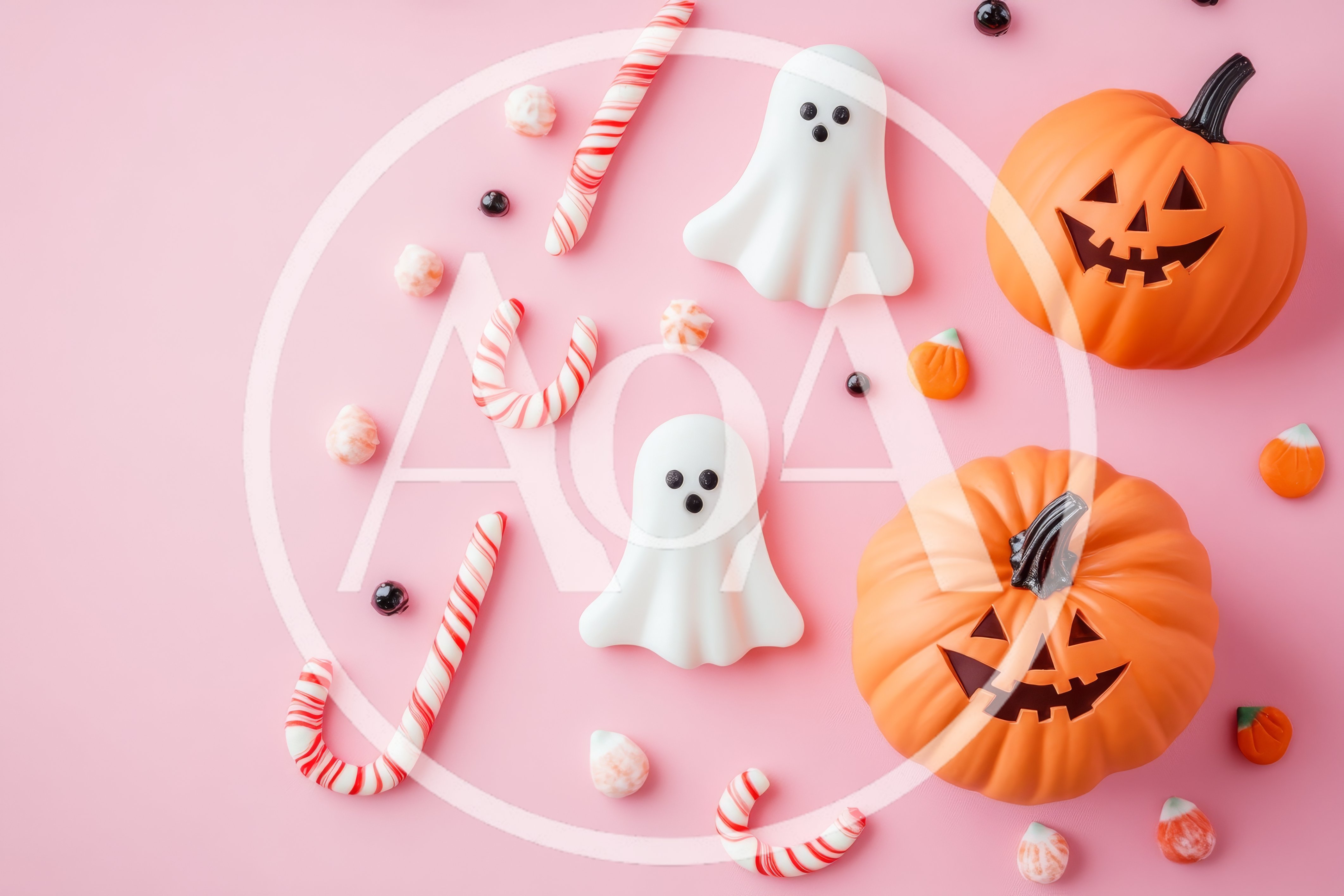 Halloween Candy and Jack-O-Lanterns on Pink Background