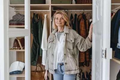 Woman Standing In Front Of Her Organized Closet