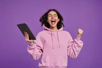 Excited Young Woman Celebrating Success With Tablet