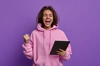 Excited Young Woman Celebrating Success With Tablet