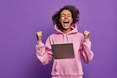 Excited Young Woman Celebrating Success With Tablet