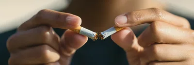 Person Breaking A Cigarette In Half