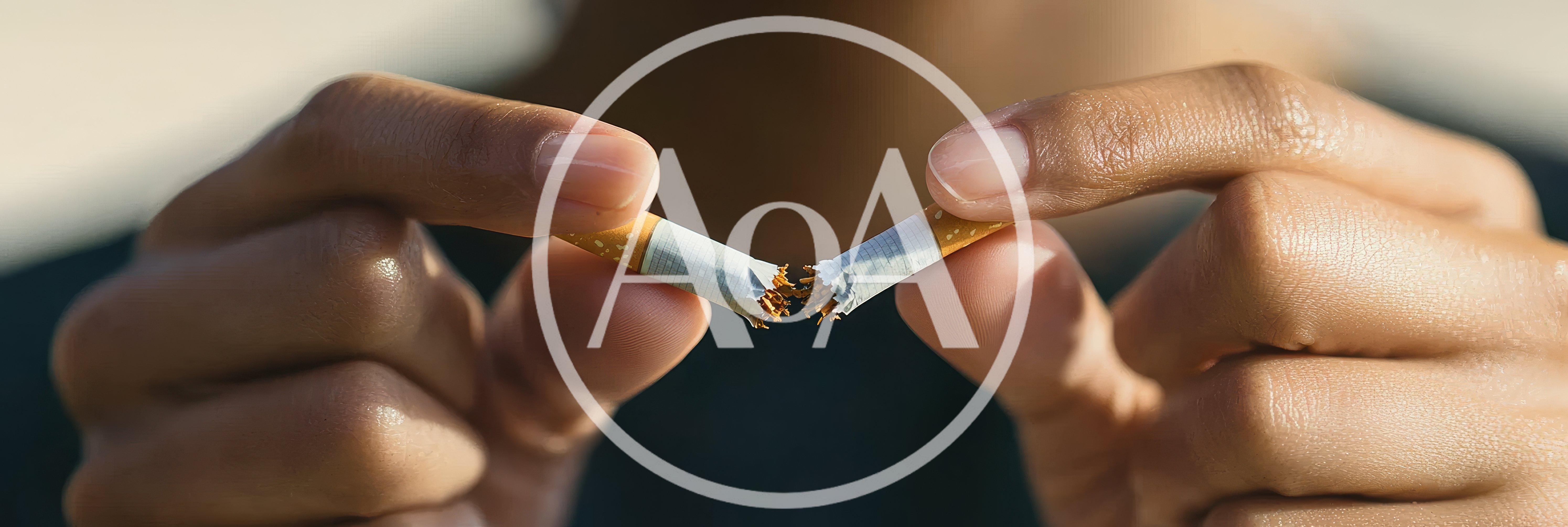 Person Breaking A Cigarette In Half