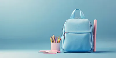 Light Blue Backpack With School Supplies On Blue Background