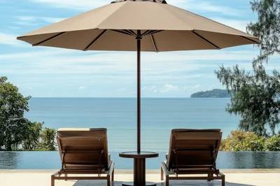 Two Sun Loungers By An Infinity Pool Overlooking The Ocean
