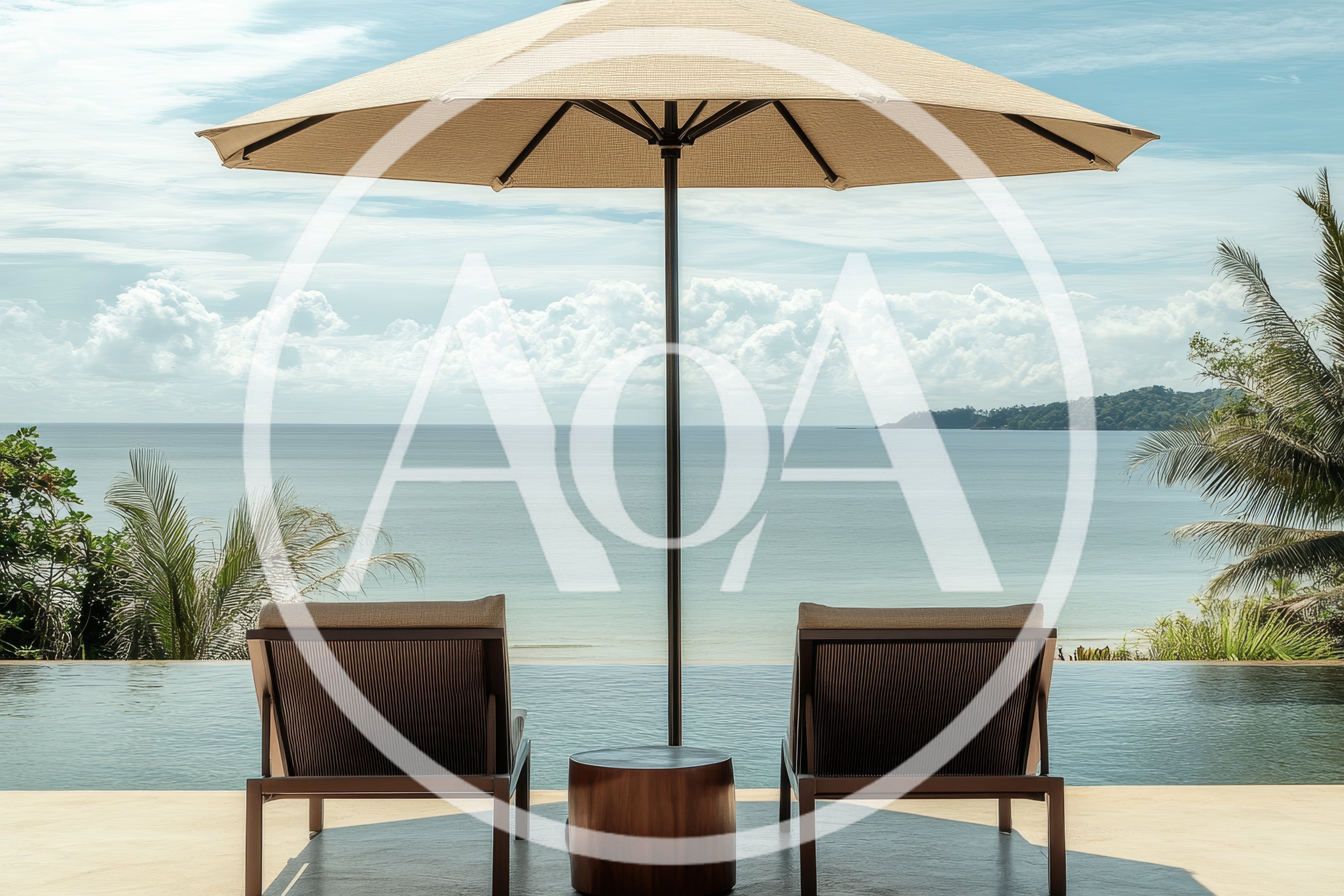 Two Lounge Chairs By An Infinity Pool Overlooking The Ocean